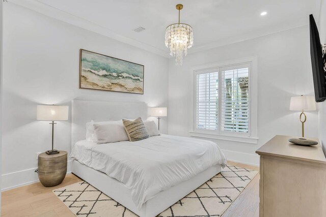 bedroom with a chandelier, baseboards, light wood-style flooring, and recessed lighting