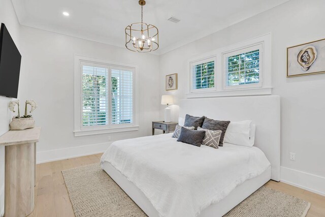 bedroom with a chandelier, light wood-type flooring, baseboards, and recessed lighting