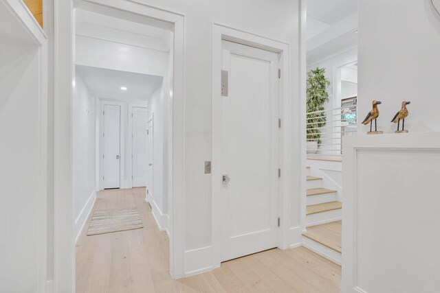 foyer entrance with light wood-style floors and recessed lighting