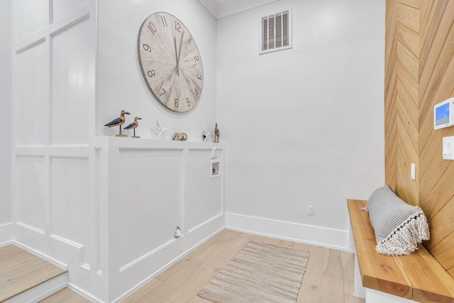 entryway featuring baseboards and light wood-type flooring