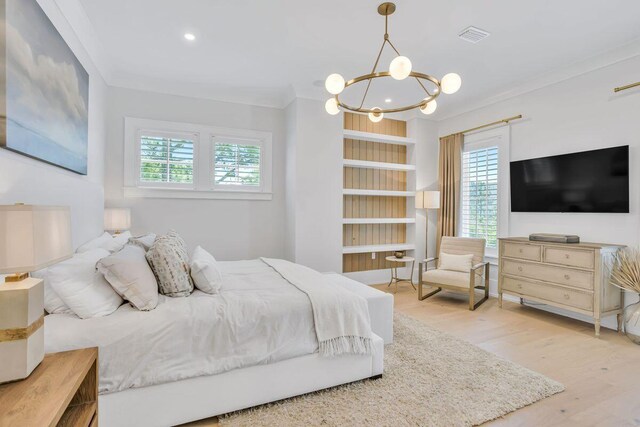 bedroom with multiple windows, wood finished floors, a chandelier, ornamental molding, and recessed lighting