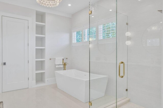 full bath with a freestanding bath, a shower stall, built in features, and recessed lighting