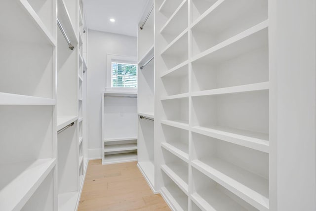 spacious closet featuring light wood-style flooring