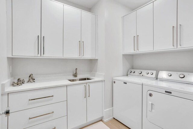 laundry area featuring washing machine and dryer and cabinet space