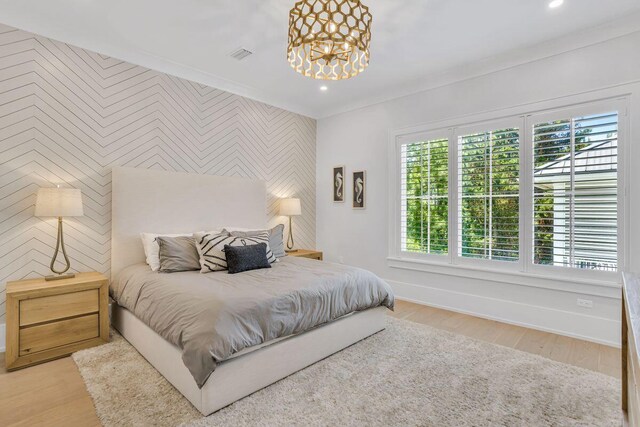 bedroom featuring an accent wall, multiple windows, baseboards, wallpapered walls, and recessed lighting