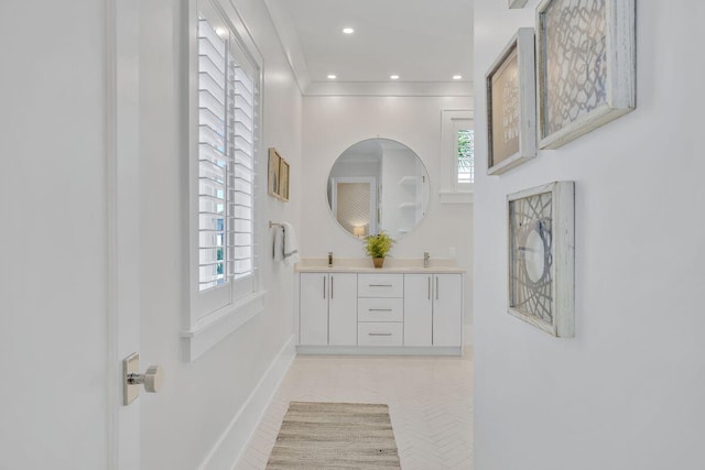 corridor featuring baseboards, plenty of natural light, and recessed lighting