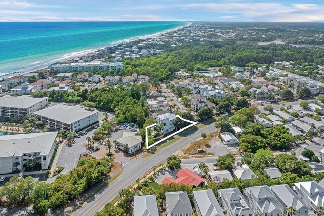 aerial overview of property's location featuring nearby suburban area, extended coastline, and property parcel outlined
