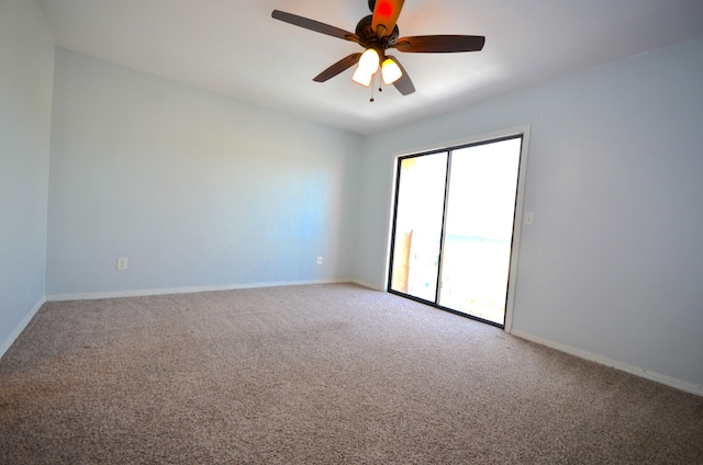 empty room featuring carpet, baseboards, and a ceiling fan