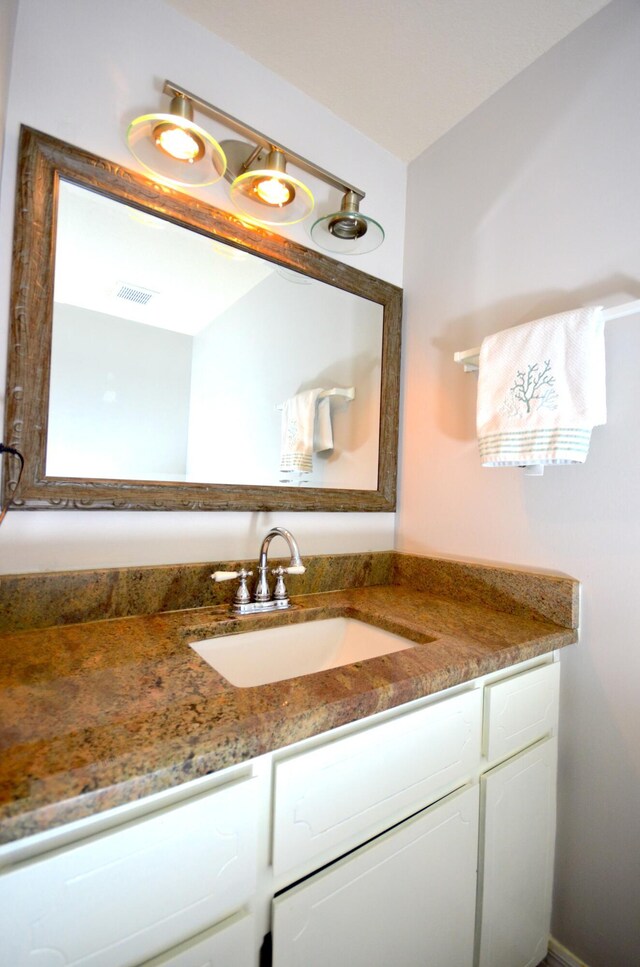 bathroom featuring visible vents and vanity