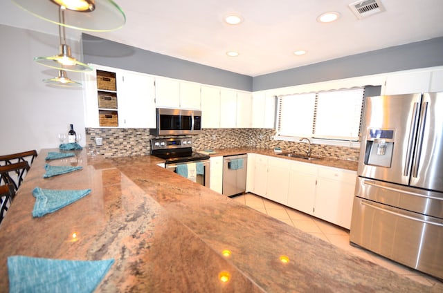 kitchen featuring a sink, visible vents, white cabinets, appliances with stainless steel finishes, and open shelves