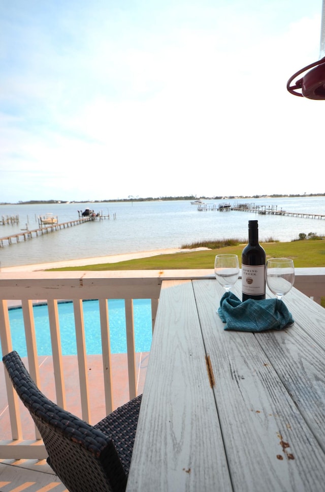 wooden terrace featuring a water view