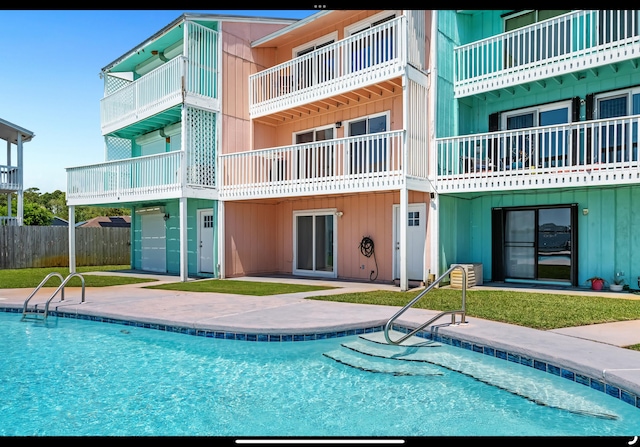 pool with a patio area and fence