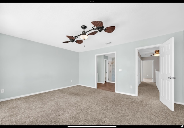 unfurnished bedroom with ceiling fan, carpet floors, visible vents, and baseboards