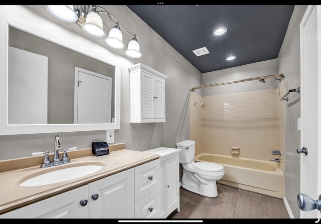 full bathroom with recessed lighting, visible vents, toilet, vanity, and bathtub / shower combination