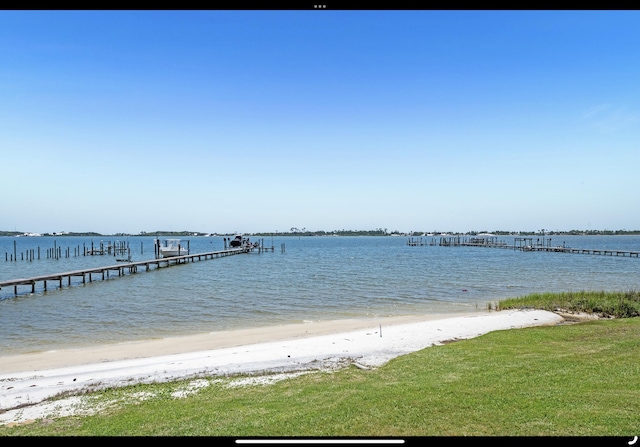 dock area featuring a view of the beach and a water view