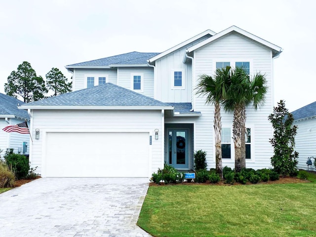 1760 Pathways Dr, Inlet Beach, FL 32461 - view of front facade featuring a garage, board and batten siding, a front lawn, and decorative driveway