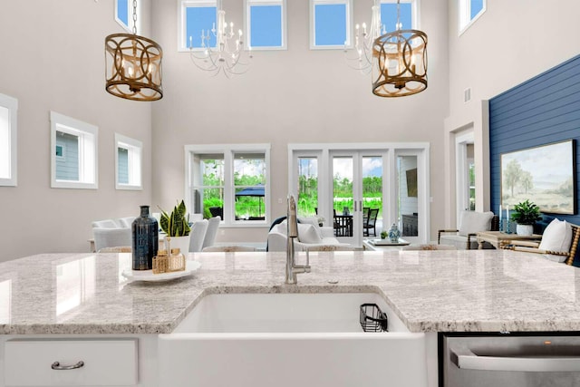 1760 Pathways Dr, Inlet Beach, FL 32461 - kitchen featuring open floor plan, a chandelier, stainless steel dishwasher, a sink, and a towering ceiling