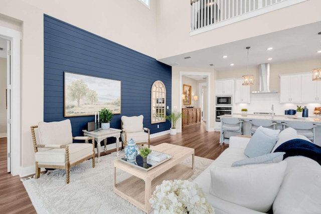 1760 Pathways Dr, Inlet Beach, FL 32461 - living area featuring wood finished floors, a chandelier, recessed lighting, and baseboards
