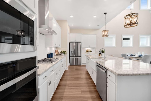 1760 Pathways Dr, Inlet Beach, FL 32461 - kitchen with stainless steel appliances, wall chimney range hood, a sink, a chandelier, and wood finished floors