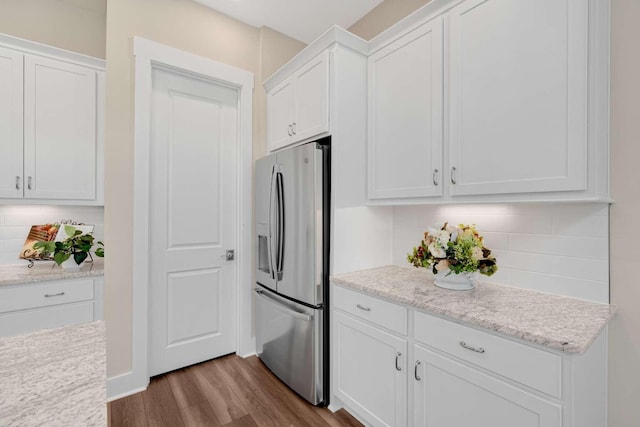 1760 Pathways Dr, Inlet Beach, FL 32461 - kitchen with stainless steel fridge, white cabinetry, dark wood-type flooring, and backsplash
