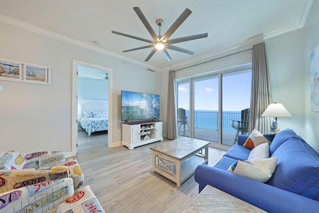 living room with ornamental molding, baseboards, light wood finished floors, and a ceiling fan