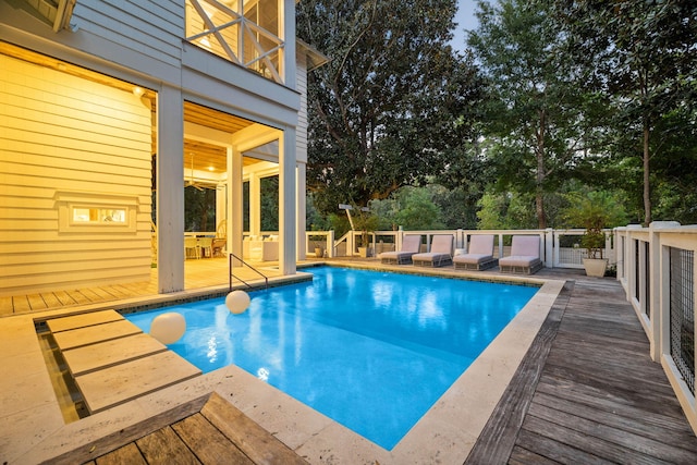 view of swimming pool with a deck and a fenced in pool