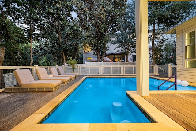 view of swimming pool with a deck and a fenced in pool