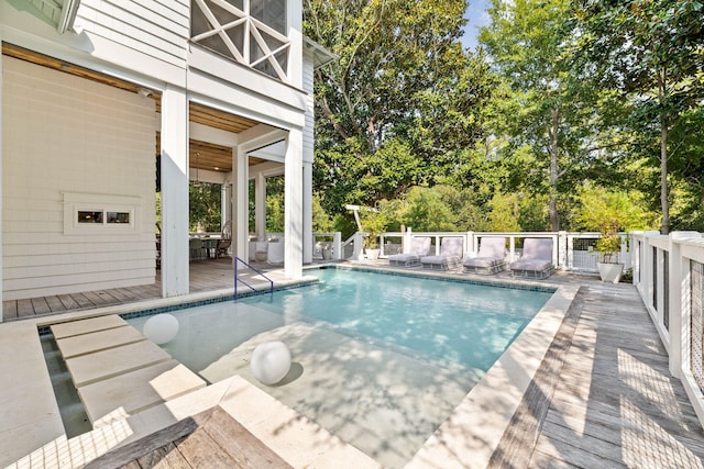 view of pool with a fenced in pool and a deck