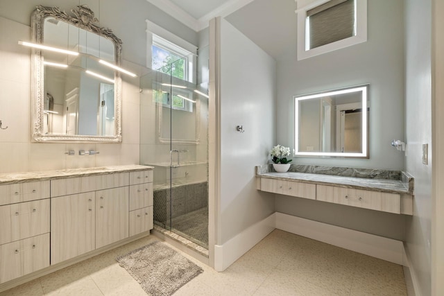 full bathroom featuring tile patterned floors, a shower stall, baseboards, and vanity