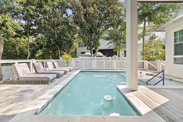 view of swimming pool with a deck and a fenced in pool