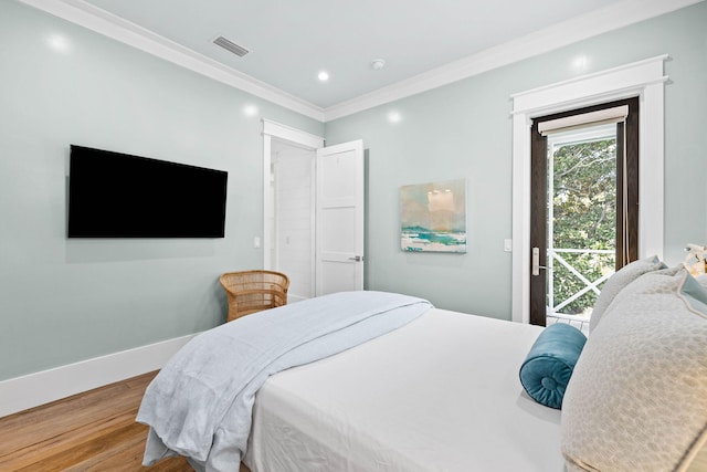 bedroom featuring access to exterior, visible vents, light wood-style flooring, ornamental molding, and baseboards