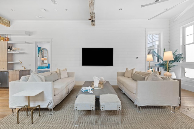 living area featuring light wood-style floors and wet bar