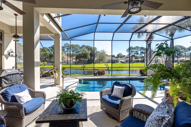 outdoor pool with glass enclosure, a patio area, outdoor lounge area, and a ceiling fan