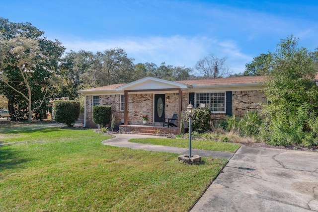 single story home featuring a front lawn and brick siding