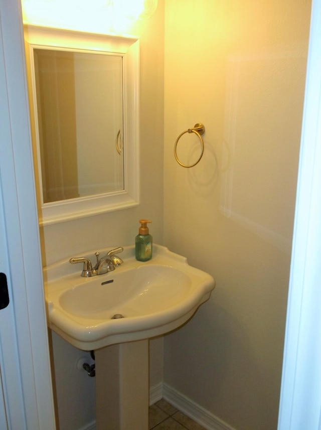 bathroom with a sink and tile patterned floors