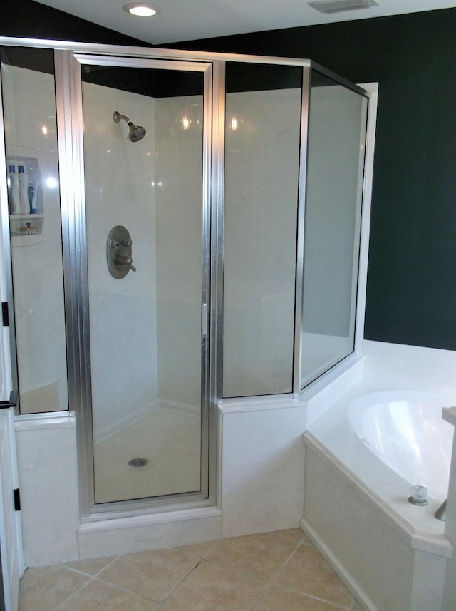 full bath featuring a stall shower, tile patterned flooring, visible vents, and a garden tub