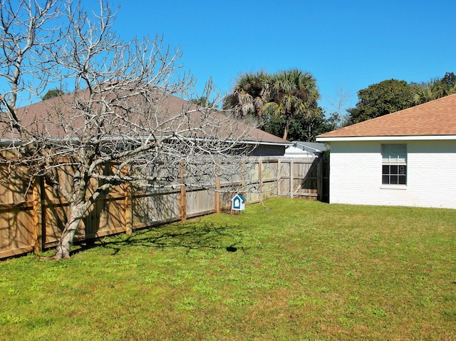 view of yard with a fenced backyard