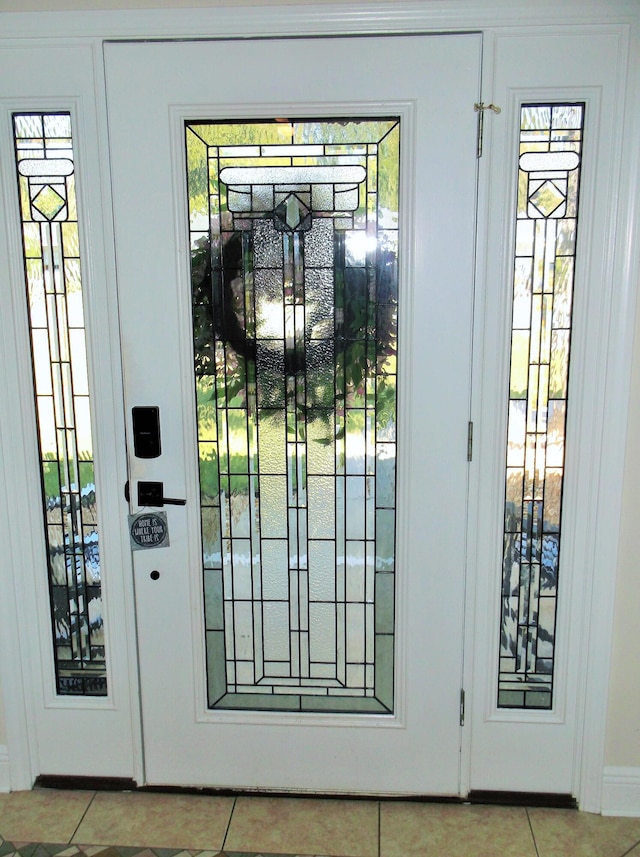 entryway with light tile patterned floors