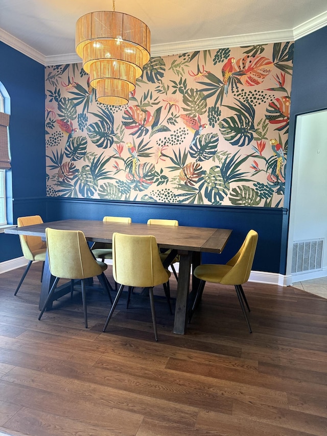 dining area with a notable chandelier, visible vents, baseboards, dark wood finished floors, and crown molding