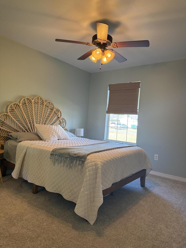 carpeted bedroom featuring ceiling fan and baseboards