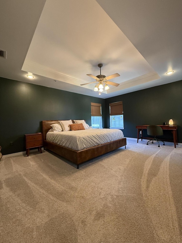 bedroom with carpet, a tray ceiling, ceiling fan, and baseboards