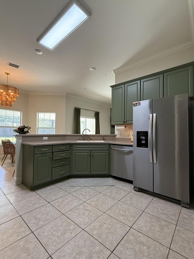 kitchen featuring visible vents, appliances with stainless steel finishes, green cabinets, and a sink