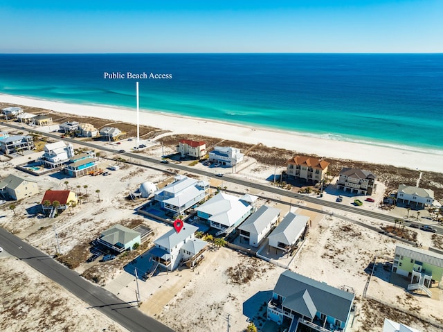 birds eye view of property featuring a beach view and a water view