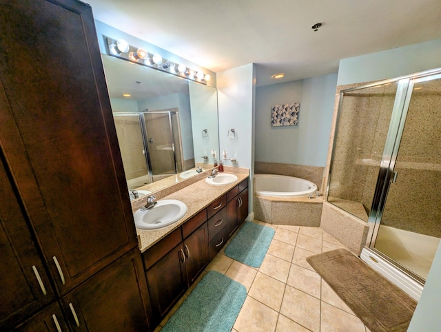 full bath featuring tile patterned flooring, a sink, a shower stall, and a bath