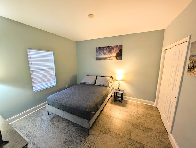bedroom featuring baseboards and a closet