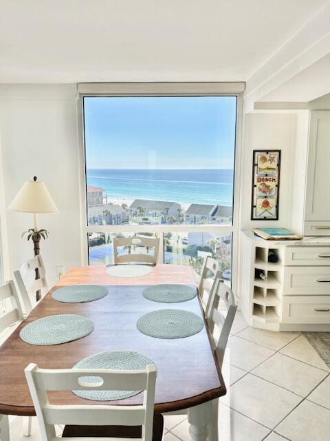 dining room featuring a water view and light tile patterned floors