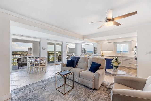 living room with light tile patterned floors and ceiling fan