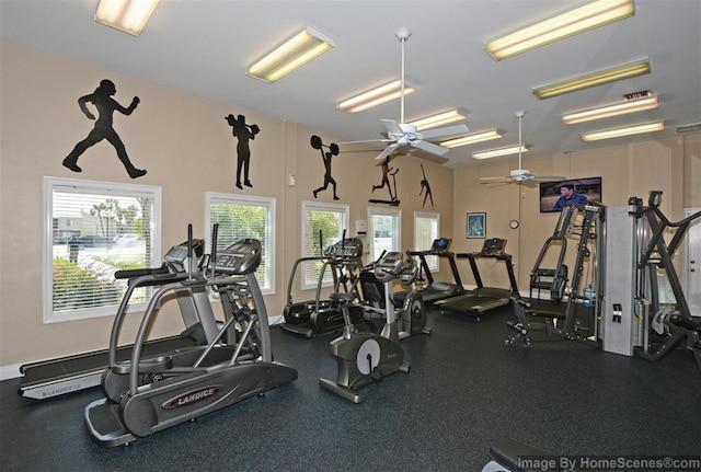 workout area featuring baseboards and a ceiling fan