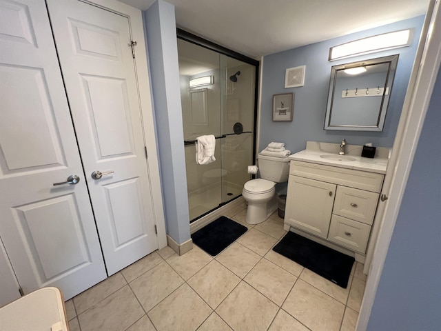 full bathroom with vanity, a stall shower, tile patterned flooring, and toilet