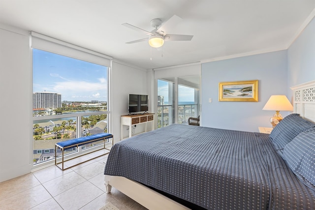 tiled bedroom featuring expansive windows, ceiling fan, multiple windows, and access to exterior